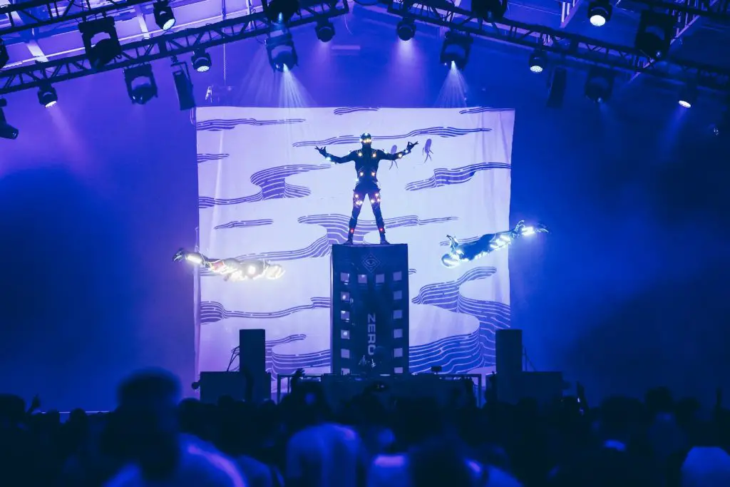 man standing on stage with lights