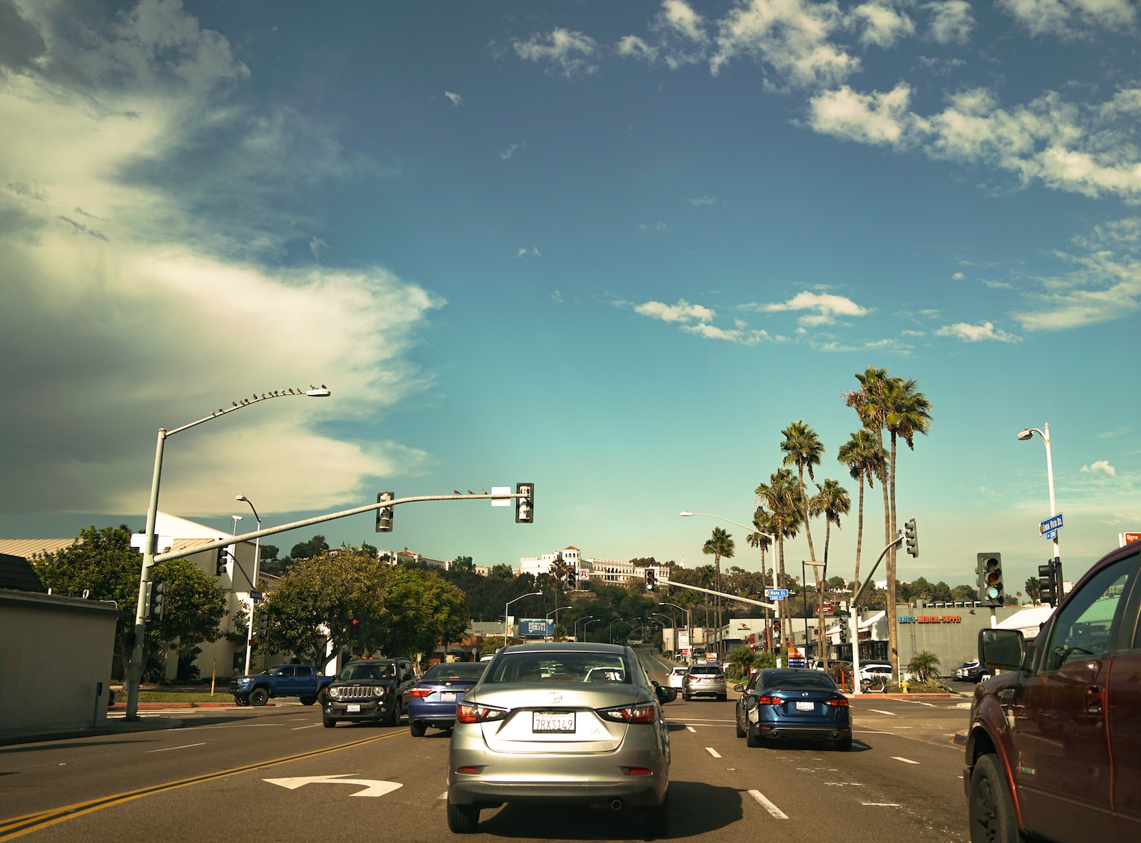 a San Diego street filled with lots of traffic under a blue sky