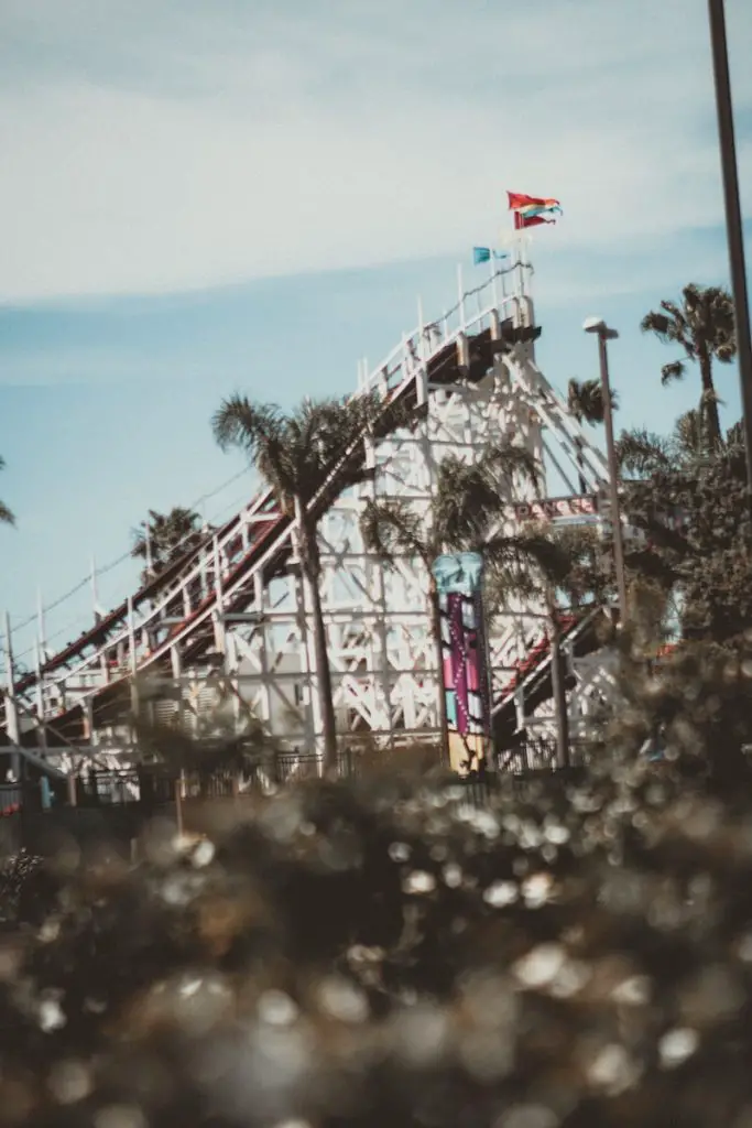 people riding on roller coaster during daytime