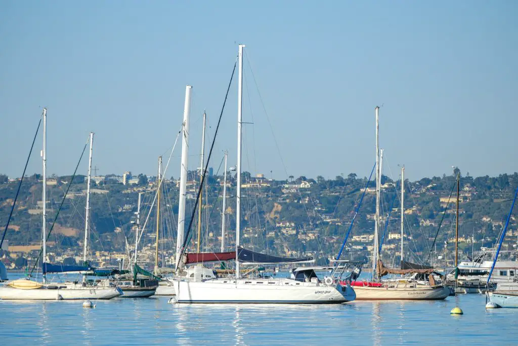 a group of sailboats floating on top of a body of water